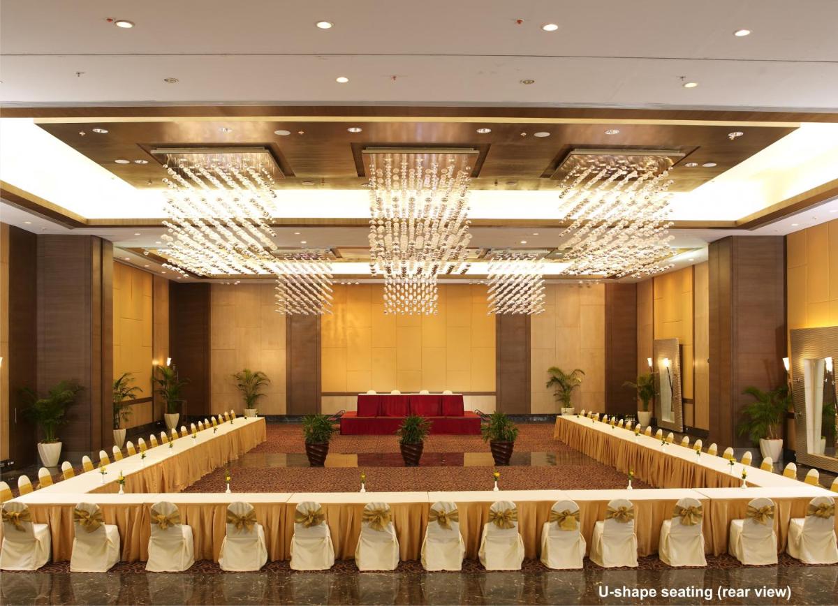 a large banquet hall with chairs and a table at The Retreat Hotel & Convention Centre in Mumbai