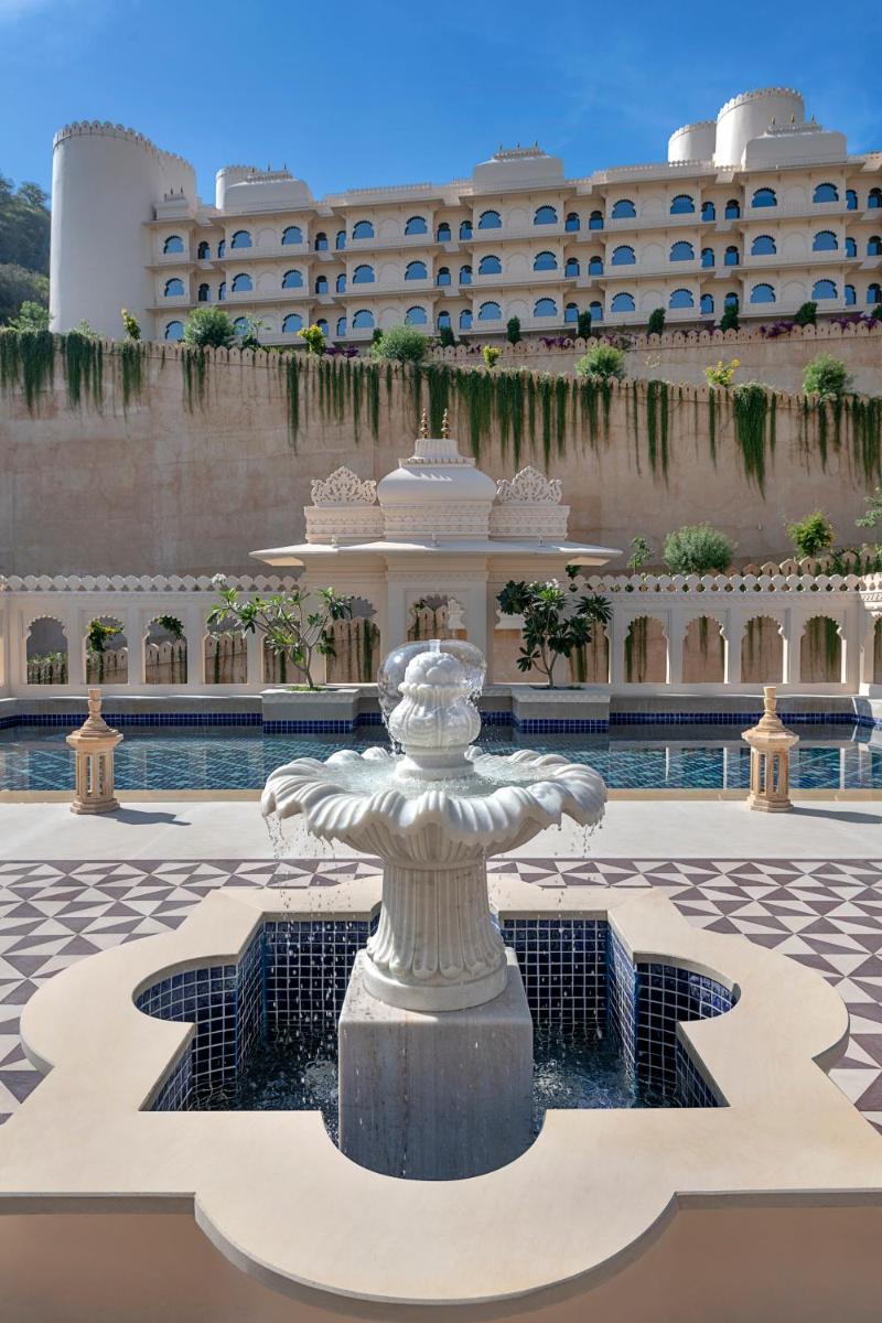 a fountain in front of a large building at Aurika, Udaipur - Luxury by Lemon Tree Hotels in Udaipur