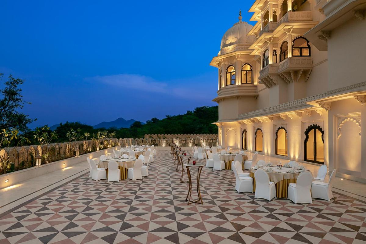 a banquet hall with white tables and chairs at Aurika, Udaipur - Luxury by Lemon Tree Hotels in Udaipur