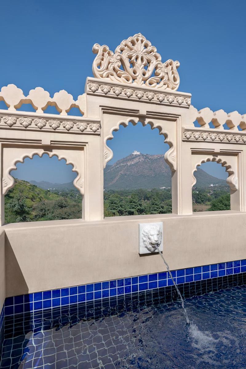 a building with three windows with a water fountain at Aurika, Udaipur - Luxury by Lemon Tree Hotels in Udaipur