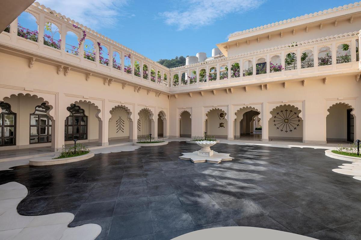 an empty courtyard of a building with a fountain at Aurika, Udaipur - Luxury by Lemon Tree Hotels in Udaipur