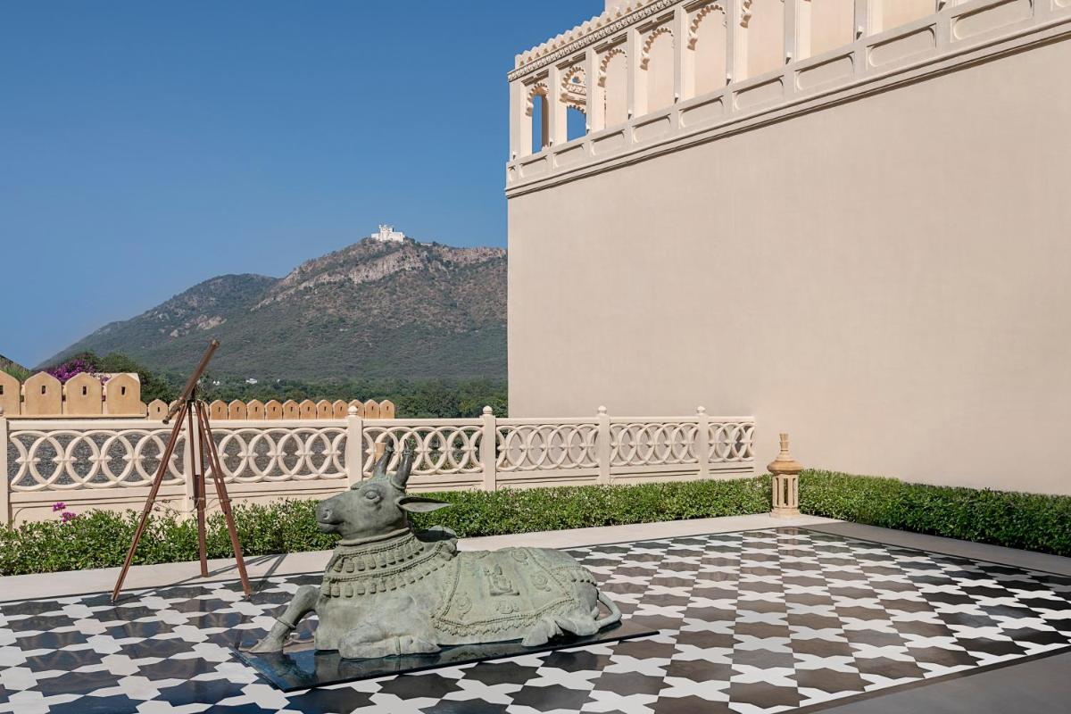 a statue of a dog sitting on a checkered floor at Aurika, Udaipur - Luxury by Lemon Tree Hotels in Udaipur