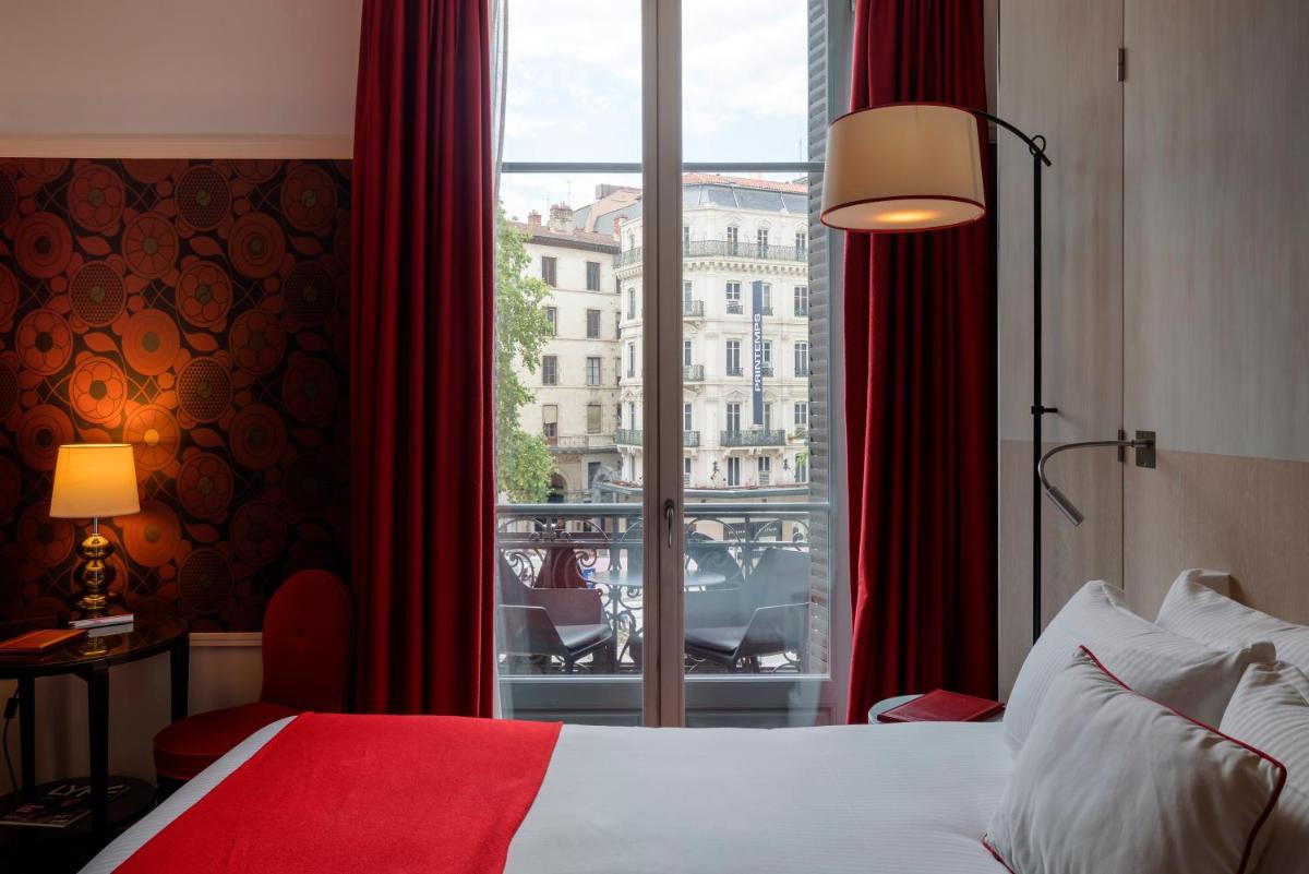 Un ou plusieurs lits dans un hébergement de l'établissement Carlton Hotel Lyon - MGallery Collection