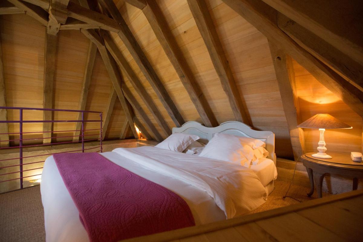 Un ou plusieurs lits dans un hébergement de l'établissement Hôtel-Spa Le Saint Cirq