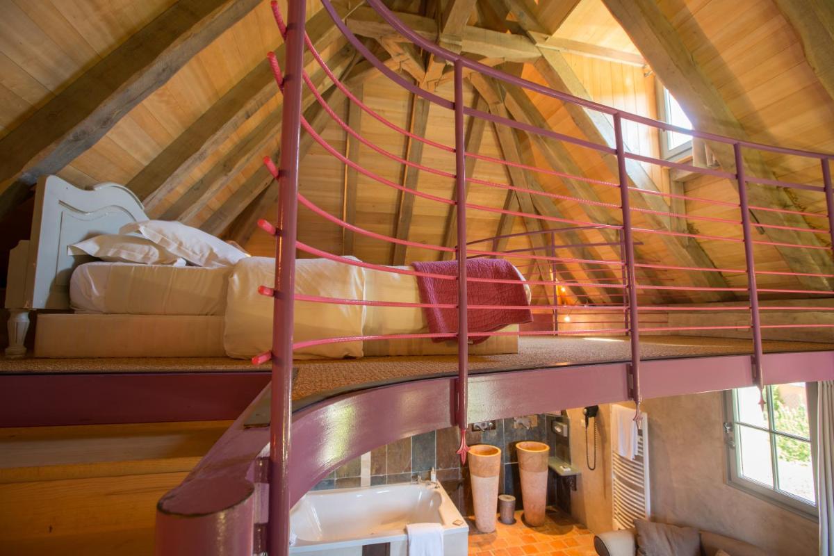 Un ou plusieurs lits dans un hébergement de l'établissement Hôtel-Spa Le Saint Cirq
