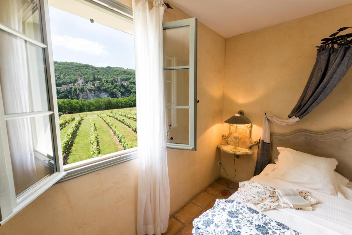 Un ou plusieurs lits dans un hébergement de l'établissement Hôtel-Spa Le Saint Cirq