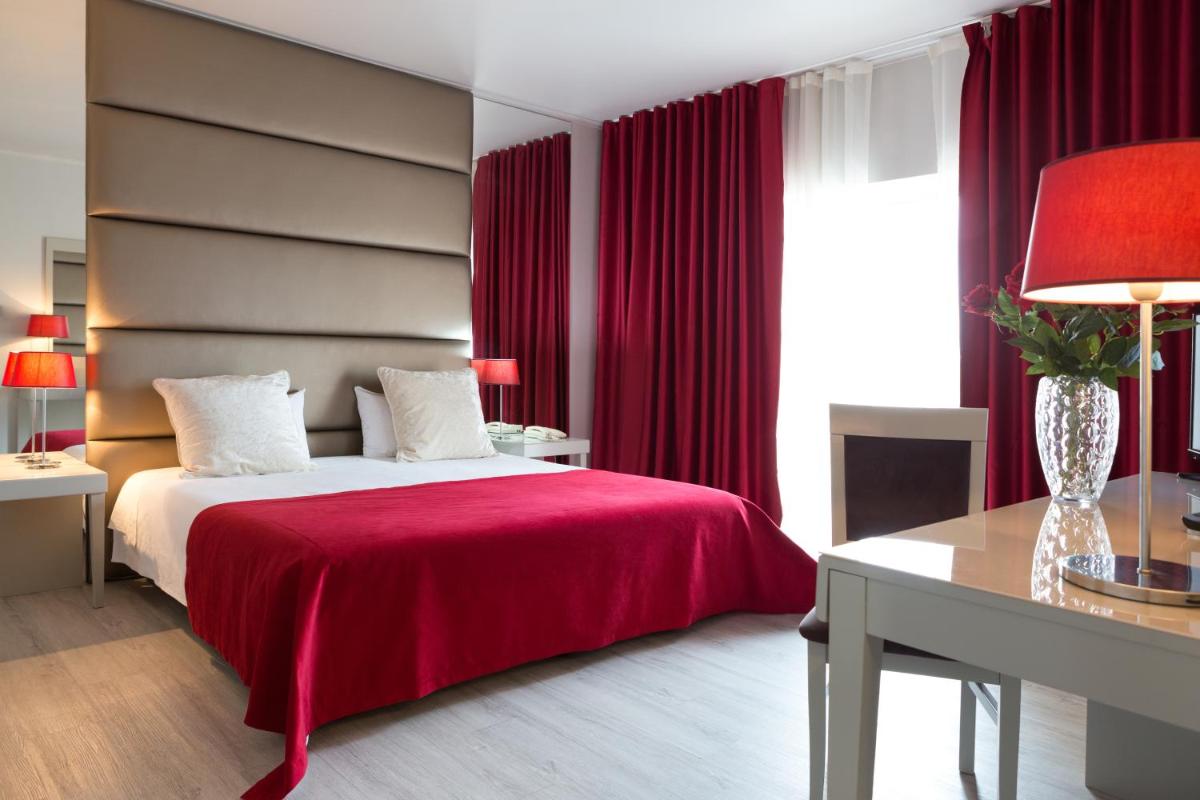 Uma cama ou camas num quarto em Hotel de Ilhavo Plaza & Spa