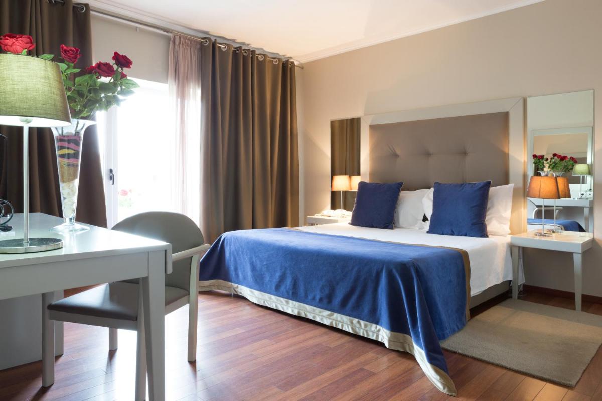 Uma cama ou camas num quarto em Hotel de Ilhavo Plaza & Spa