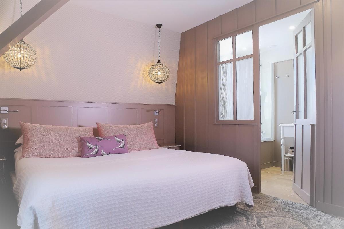 Un ou plusieurs lits dans un hébergement de l'établissement Les Glycines - Hôtel & Spa - Teritoria