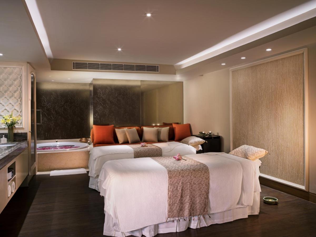 a hotel room with two beds and a bath tub at Taj Palace, New Delhi in New Delhi a hotel room with two beds and a bath tub at Taj Palace, New Delhi in New Delhi