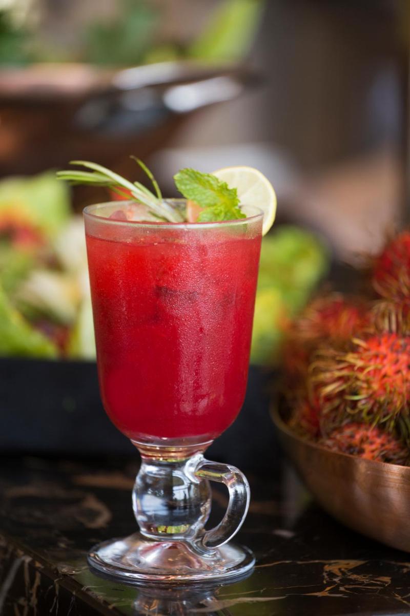 a red drink in a glass on a table at Taj Palace, New Delhi in New Delhi a red drink in a glass on a table at Taj Palace, New Delhi in New Delhi