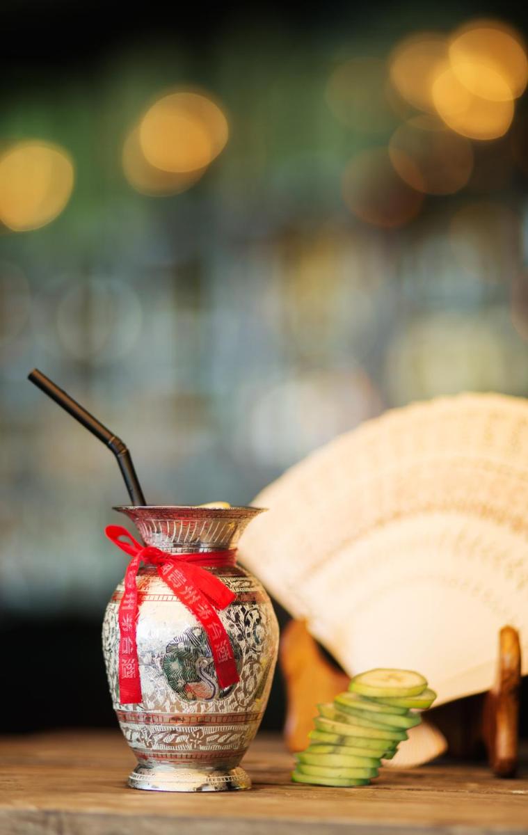 a vase sitting on a table with a book at Taj Palace, New Delhi in New Delhi a vase sitting on a table with a book at Taj Palace, New Delhi in New Delhi