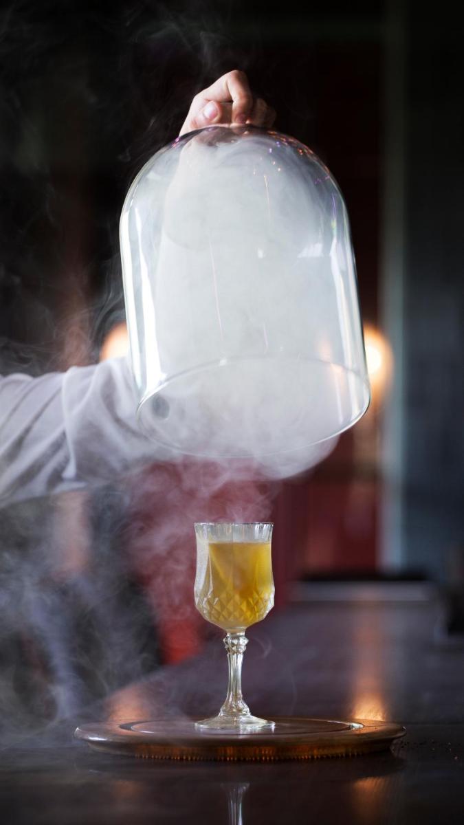 a person is pouring a drink into a glass at Taj Palace, New Delhi in New Delhi a person is pouring a drink into a glass at Taj Palace, New Delhi in New Delhi