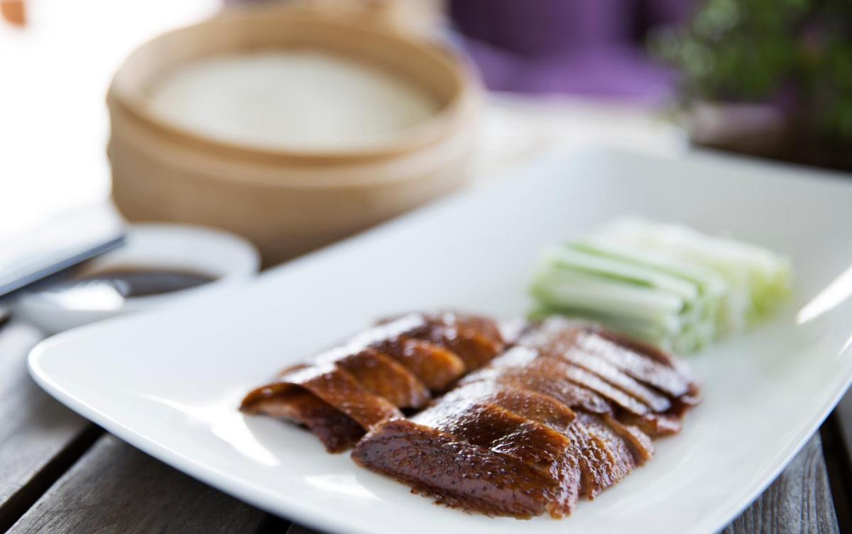 a white plate with some food on a table at Taj Palace, New Delhi in New Delhi a white plate with some food on a table at Taj Palace, New Delhi in New Delhi