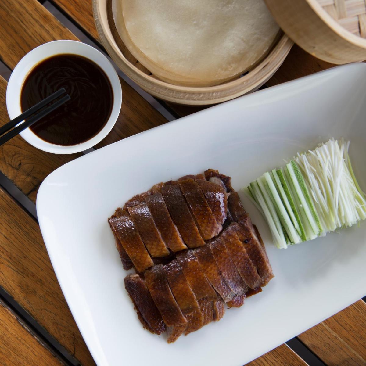 a white plate with a piece of meat and celery at Taj Palace, New Delhi in New Delhi a white plate with a piece of meat and celery at Taj Palace, New Delhi in New Delhi
