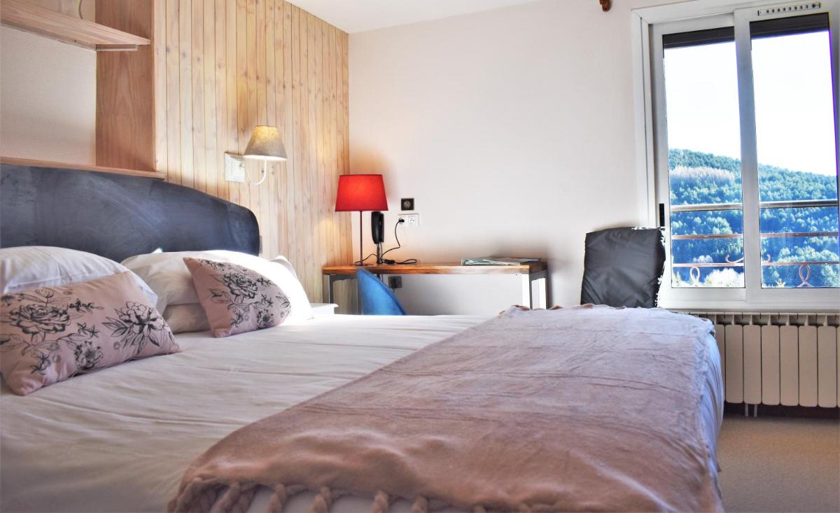 Un ou plusieurs lits dans un hébergement de l'établissement Hotel Corrieu