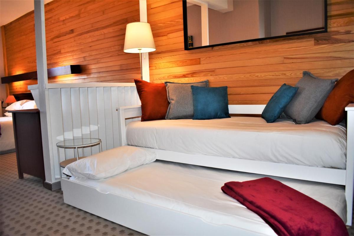 Un ou plusieurs lits dans un hébergement de l'établissement Hotel Corrieu