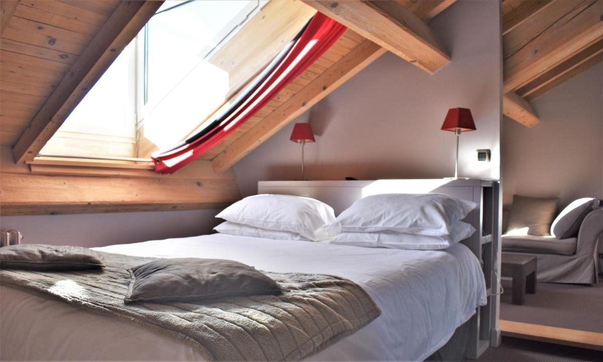 Un ou plusieurs lits dans un hébergement de l'établissement Hotel Corrieu