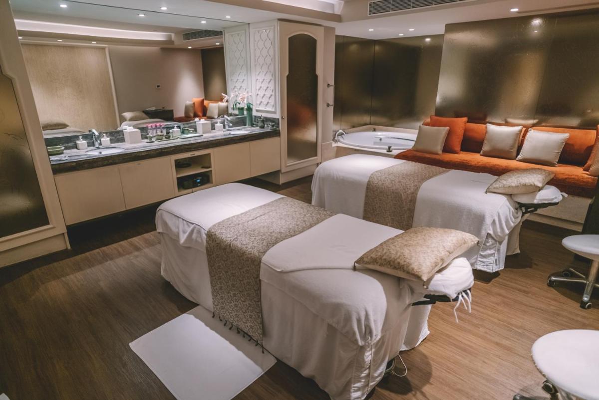 a hotel room with two beds and a bath tub at Taj Palace, New Delhi in New Delhi a hotel room with two beds and a bath tub at Taj Palace, New Delhi in New Delhi