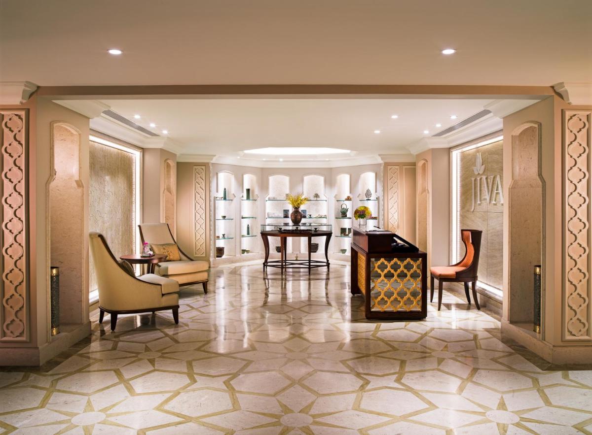 a lobby with a table and chairs and a dining room at Taj Palace, New Delhi in New Delhi a lobby with a table and chairs and a dining room at Taj Palace, New Delhi in New Delhi