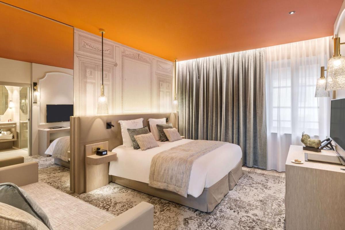 Un ou plusieurs lits dans un hébergement de l'établissement Hôtel & Spa Les Sept Fontaines Best Western Premier