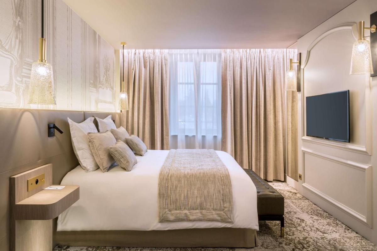 Un ou plusieurs lits dans un hébergement de l'établissement Hôtel & Spa Les Sept Fontaines Best Western Premier