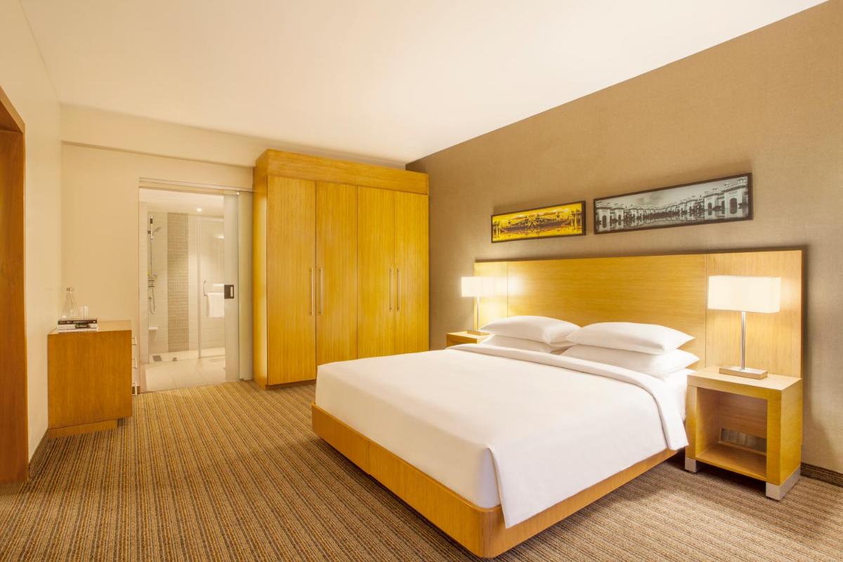 a large bedroom with a large white bed in it at Hyatt Place Hyderabad Banjara Hills in Hyderabad