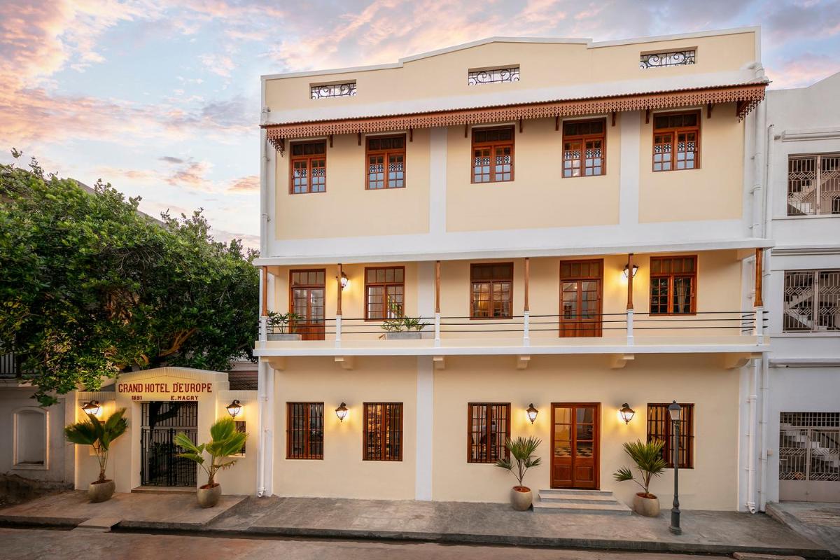a large white building with a lot of windows at Grand Hotel D'Europe in Puducherry +30 photos