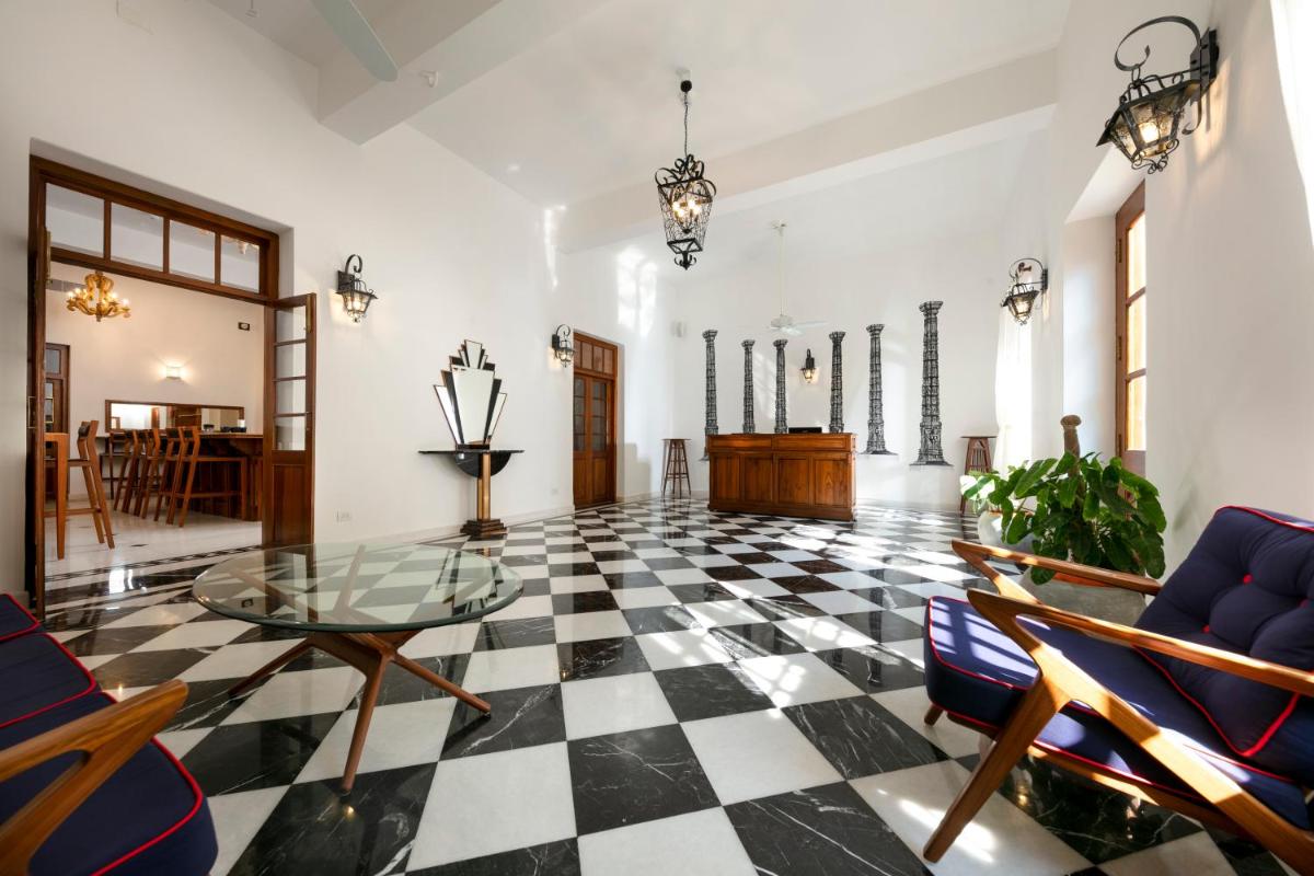 a living room with a black and white checkered floor at Grand Hotel D'Europe in Puducherry