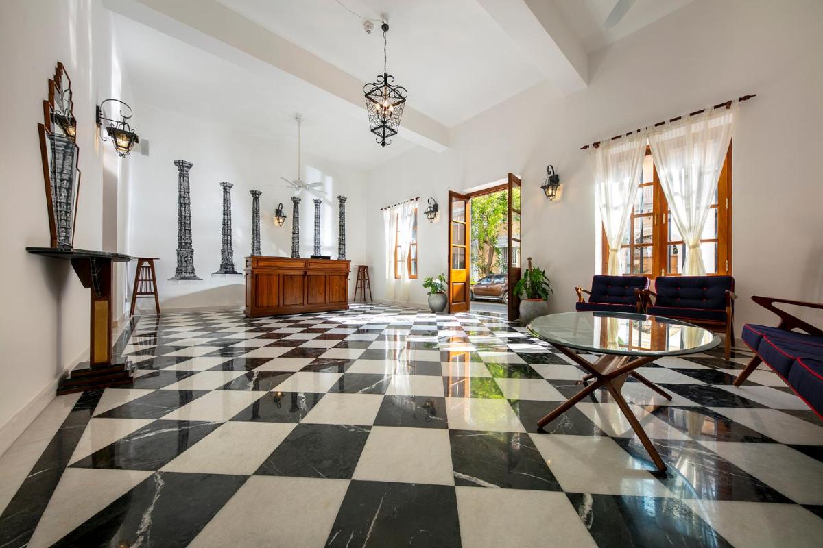 a living room with a black and white checkered floor at Grand Hotel D'Europe in Puducherry