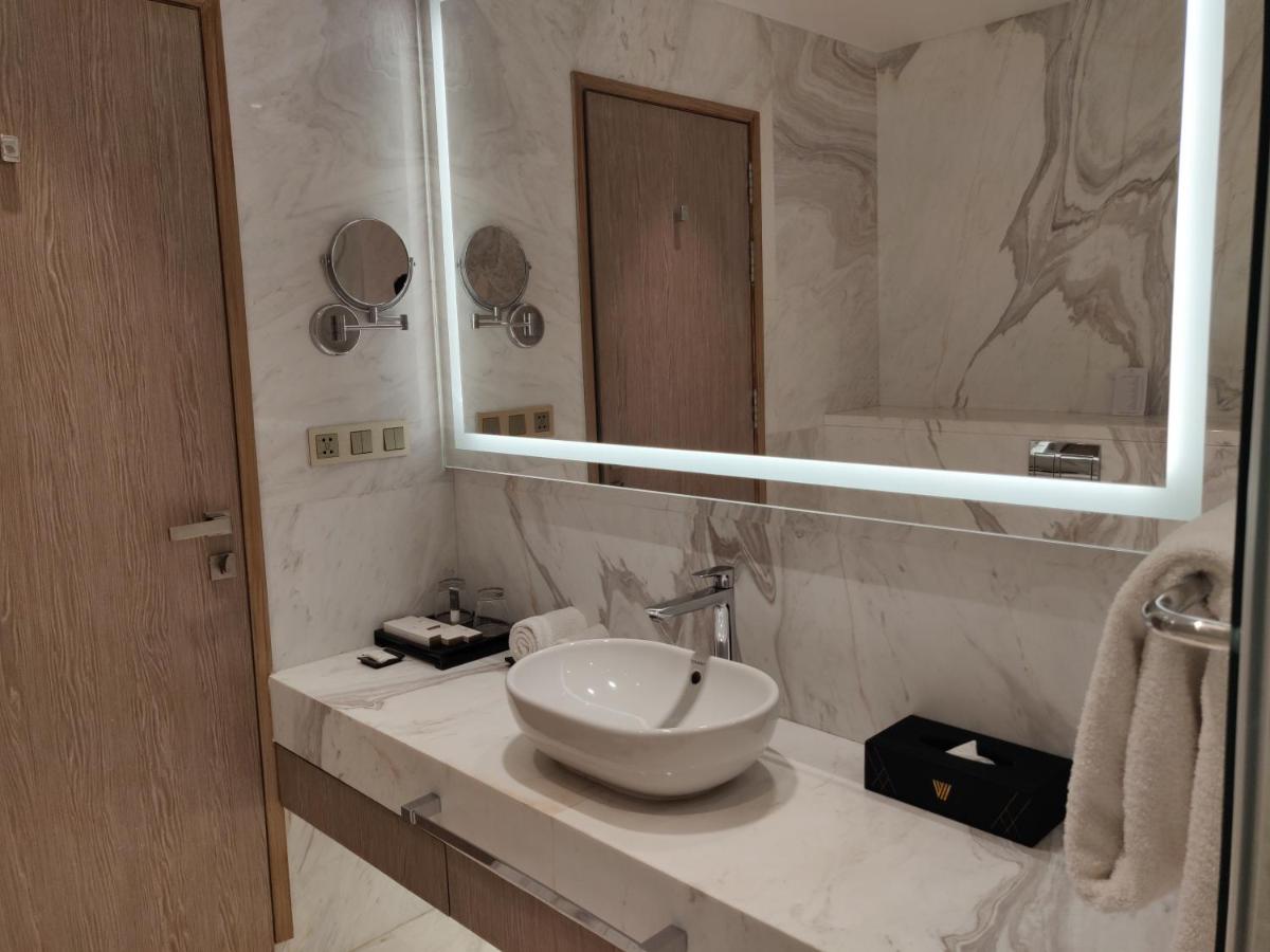 a bathroom with a sink and a mirror at Vividus in Bengaluru a bathroom with a sink and a mirror at Vividus in Bengaluru