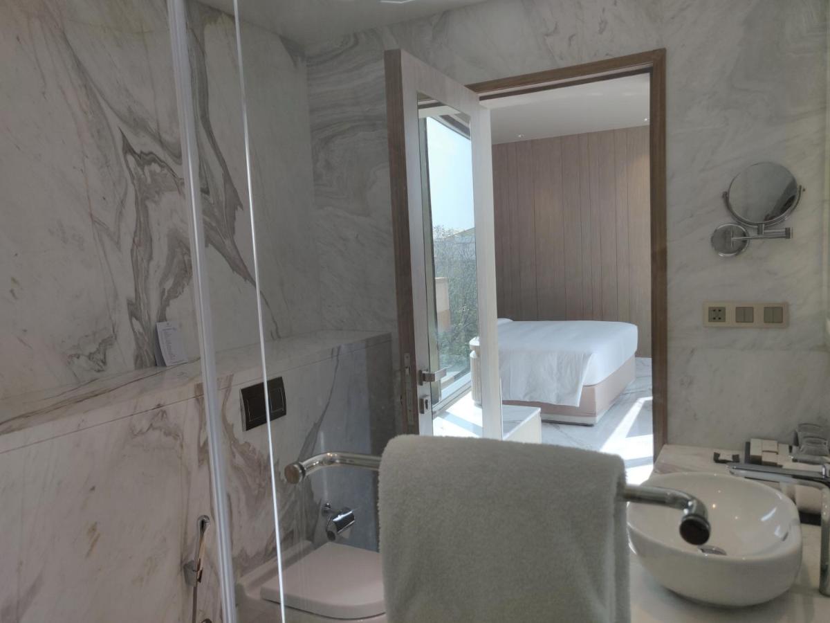 a bathroom with a sink and a toilet and a shower at Vividus in Bengaluru a bathroom with a sink and a toilet and a shower at Vividus in Bengaluru