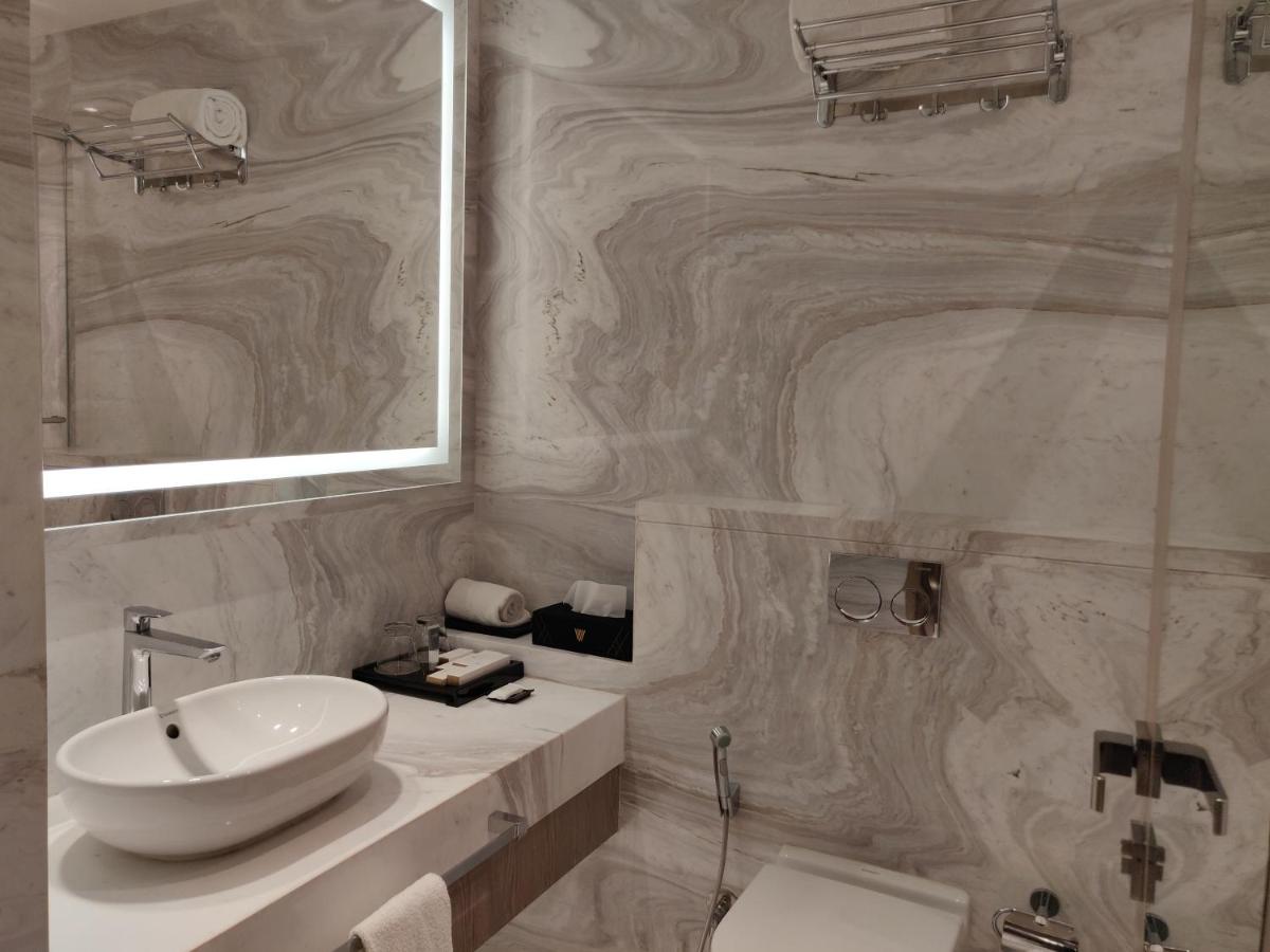 a bathroom with a sink and a toilet and a mirror at Vividus in Bengaluru a bathroom with a sink and a toilet and a mirror at Vividus in Bengaluru