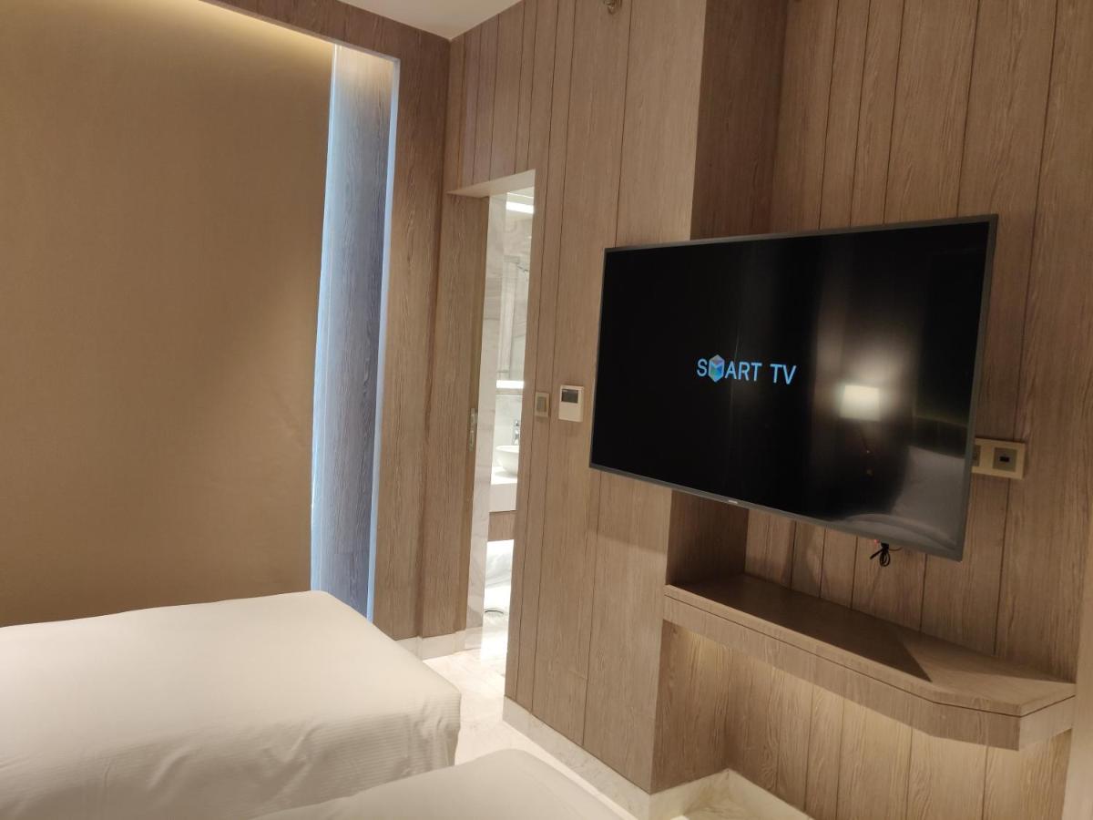 a bedroom with a flat screen tv on a wall at Vividus in Bengaluru a bedroom with a flat screen tv on a wall at Vividus in Bengaluru