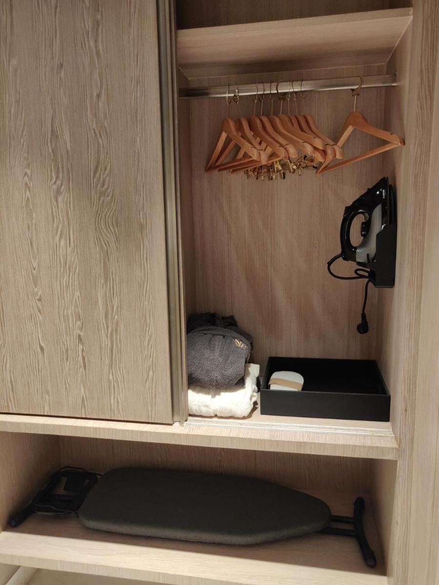 a cupboard with a shelf with some items in it at Vividus in Bengaluru a cupboard with a shelf with some items in it at Vividus in Bengaluru