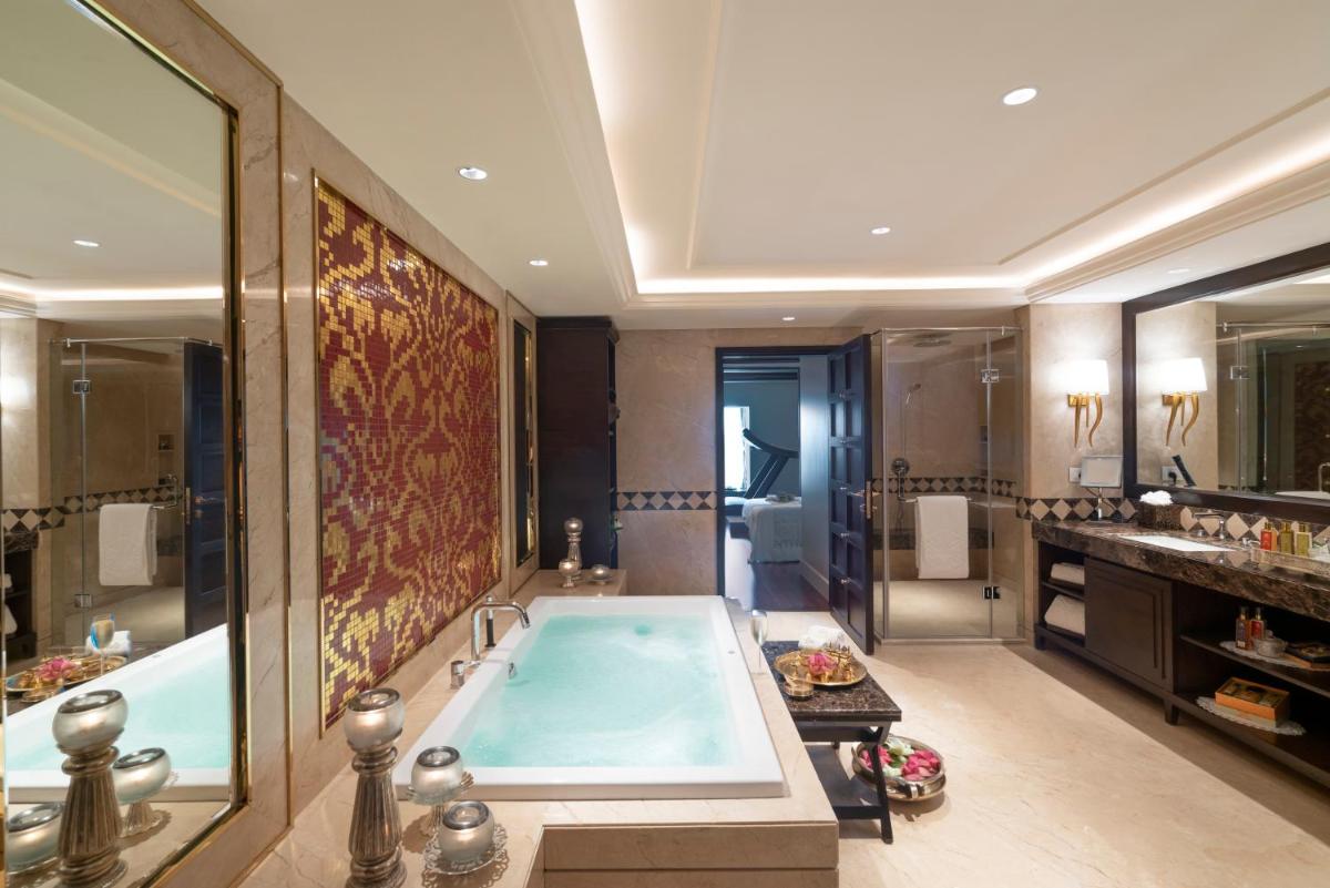 a large bathroom with a tub and a sink at Taj Coromandel in Chennai