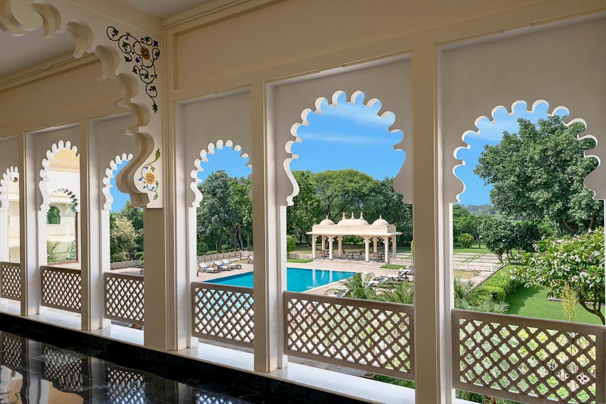a view of the pool from the balcony of a resort at Trident Udaipur in Udaipur