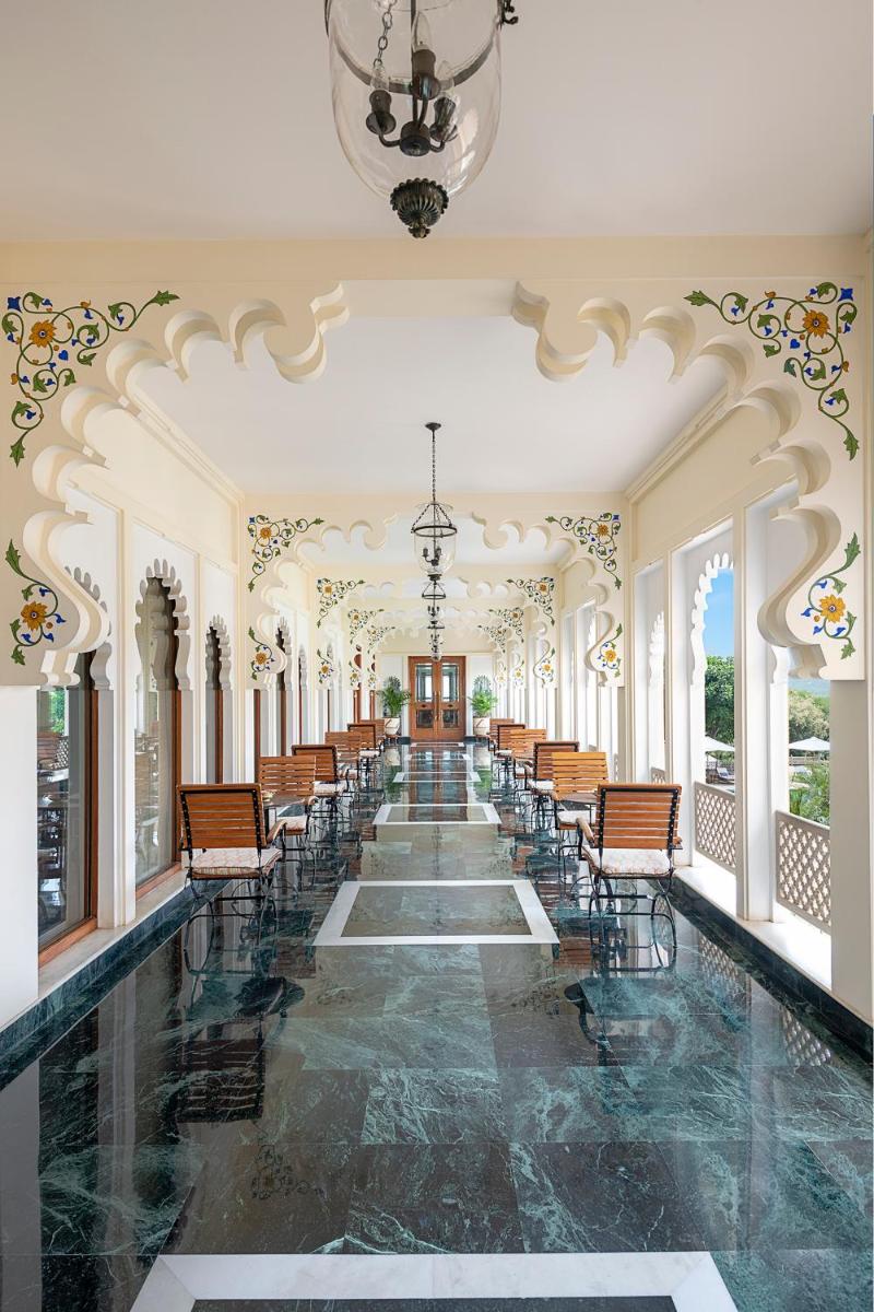 an empty hall with chairs and a chandelier at Trident Udaipur in Udaipur