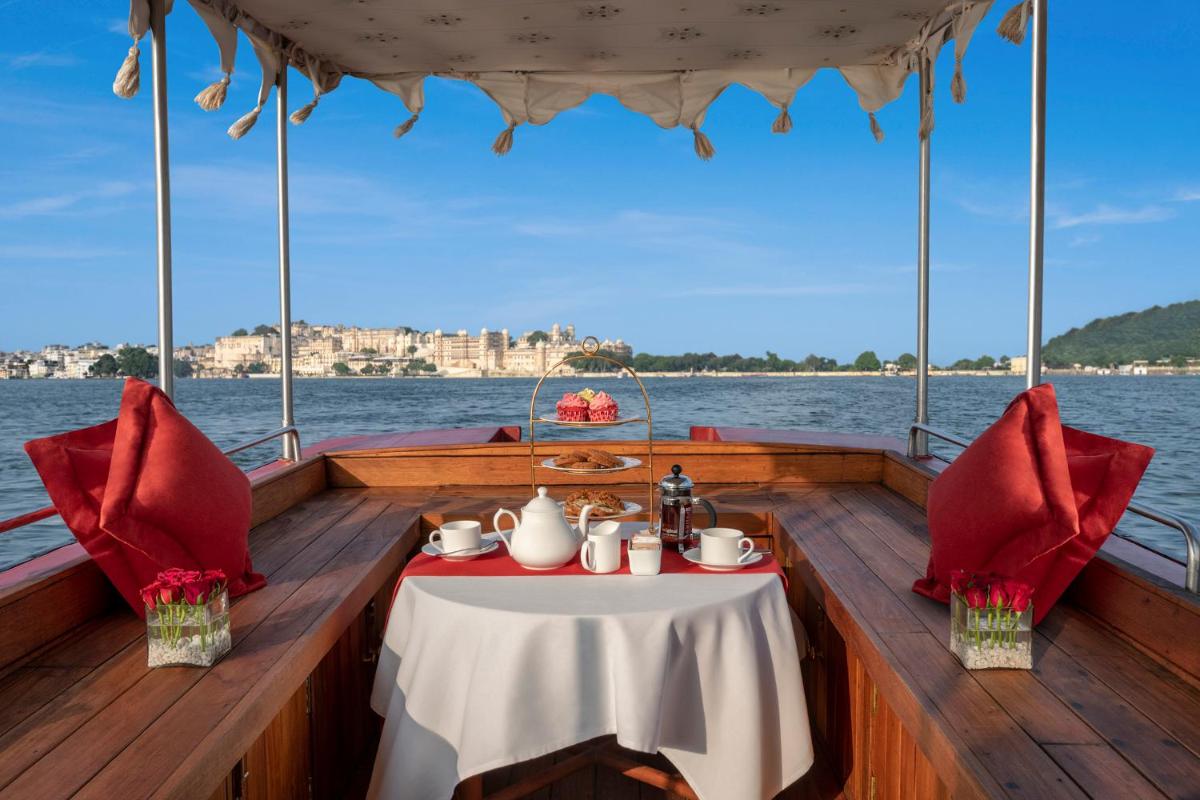 a table on the back of a boat on the water at Trident Udaipur in Udaipur