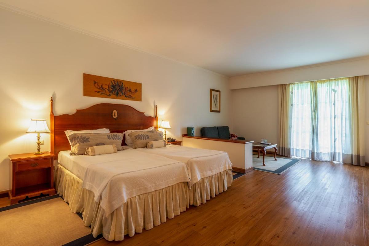 Uma cama ou camas num quarto em Quintinha Sao Joao Hotel & Spa