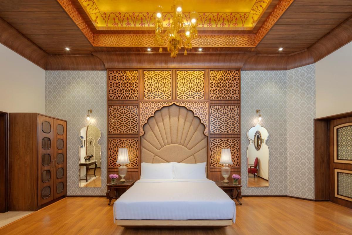 a bedroom with a bed and a chandelier at Radisson Jodhpur in Jodhpur