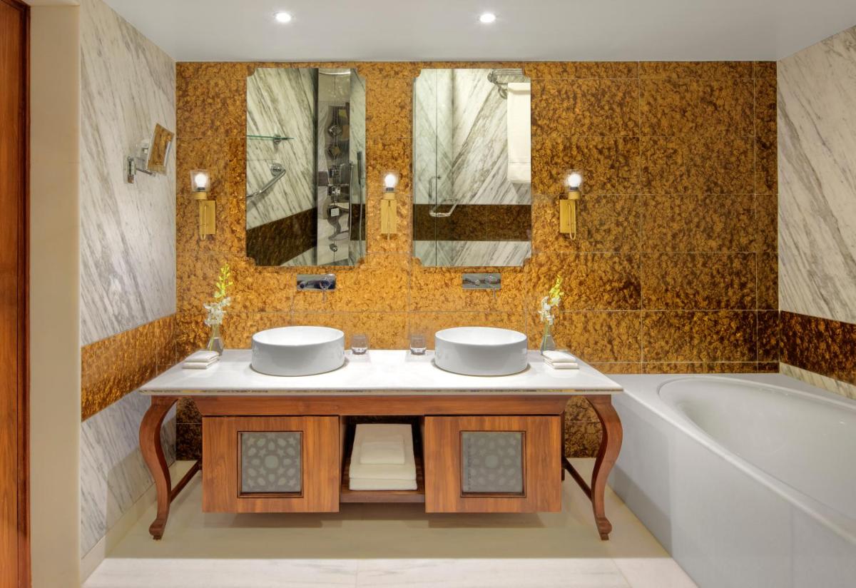 a bathroom with two sinks and a bath tub at Radisson Jodhpur in Jodhpur