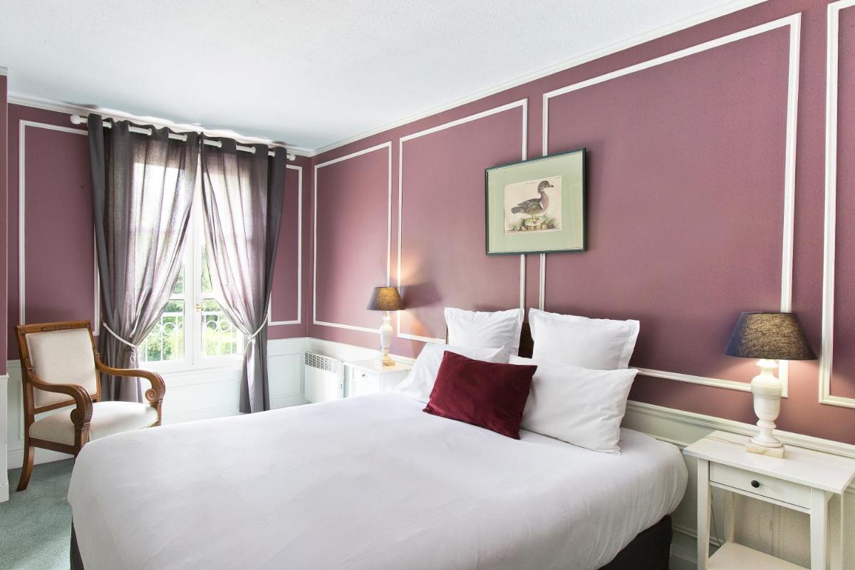 Un ou plusieurs lits dans un hébergement de l'établissement Château Hôtel, Restaurant & Spa De La Commanderie