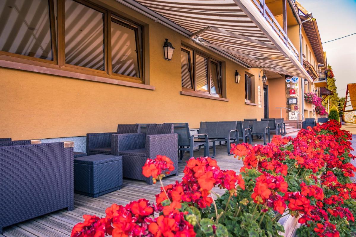 Coin salon dans l'établissement Hotel Spa et Restaurant Au Chasseur