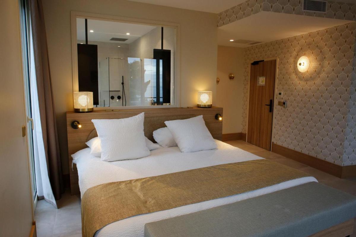 Un ou plusieurs lits dans un hébergement de l'établissement Splendid Hôtel & Spa