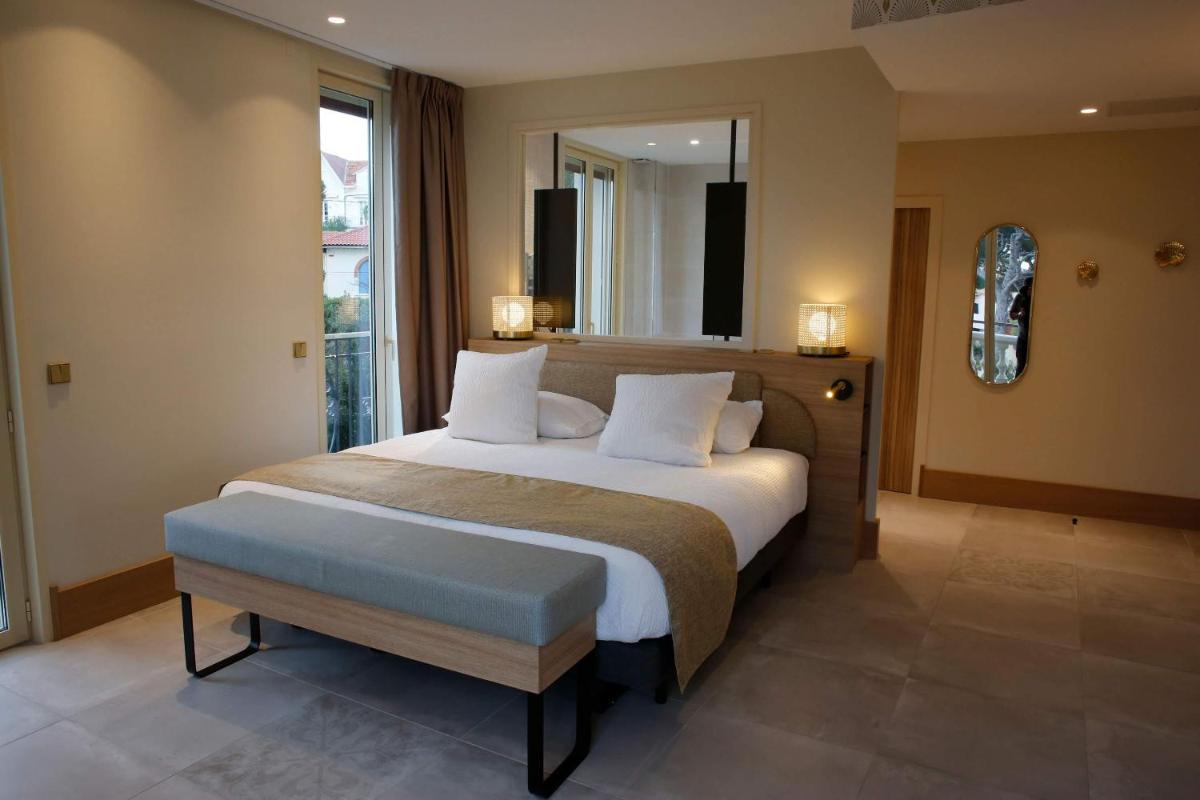 Un ou plusieurs lits dans un hébergement de l'établissement Splendid Hôtel & Spa