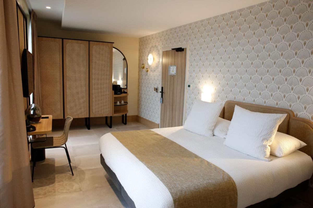 Un ou plusieurs lits dans un hébergement de l'établissement Splendid Hôtel & Spa