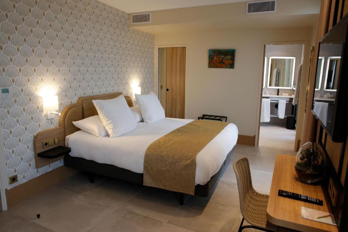 Un ou plusieurs lits dans un hébergement de l'établissement Splendid Hôtel & Spa