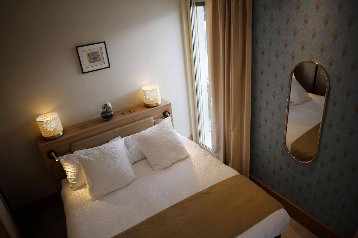 Un ou plusieurs lits dans un hébergement de l'établissement Splendid Hôtel & Spa