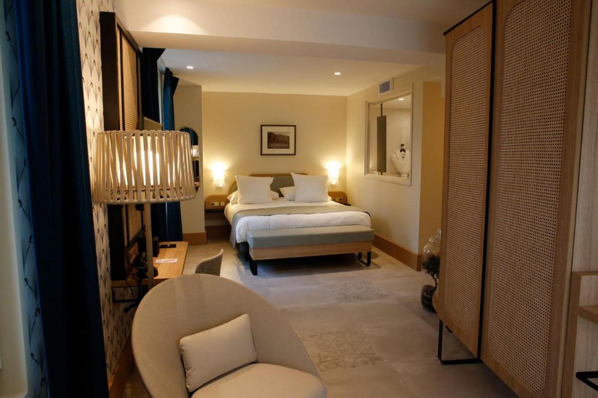Un ou plusieurs lits dans un hébergement de l'établissement Splendid Hôtel & Spa